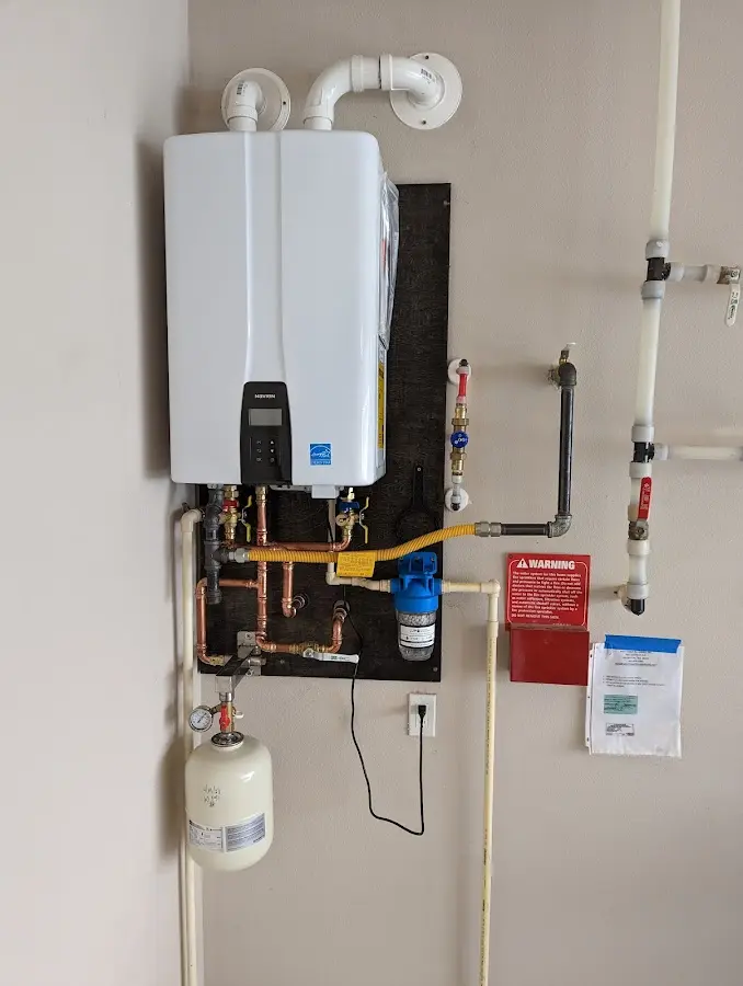 Professional plumber installing copper piping in a Longboat Key home